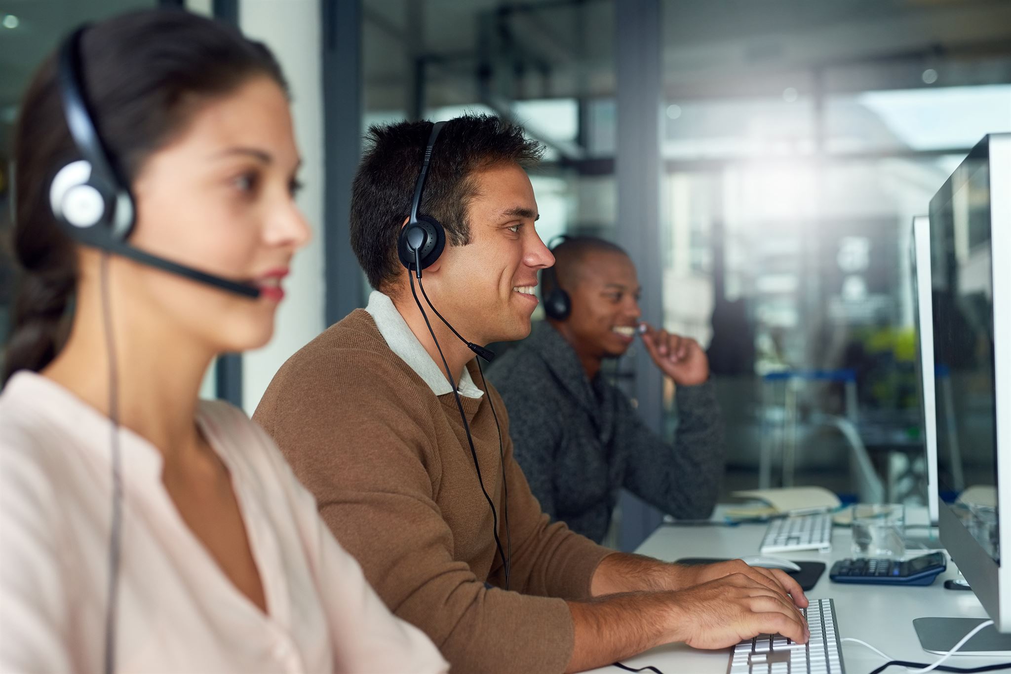 People-wearing-headphones-working-on-computers